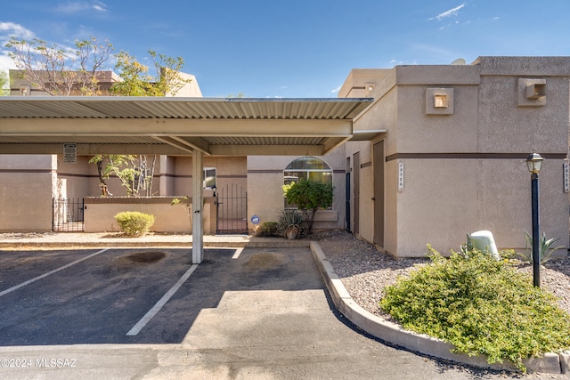 view of vehicle parking with a carport