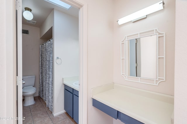 bathroom with vanity, toilet, and tile patterned floors