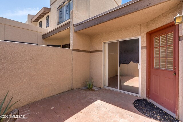 property entrance featuring a patio area