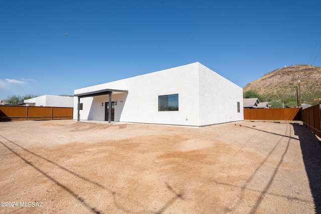 rear view of house featuring a mountain view