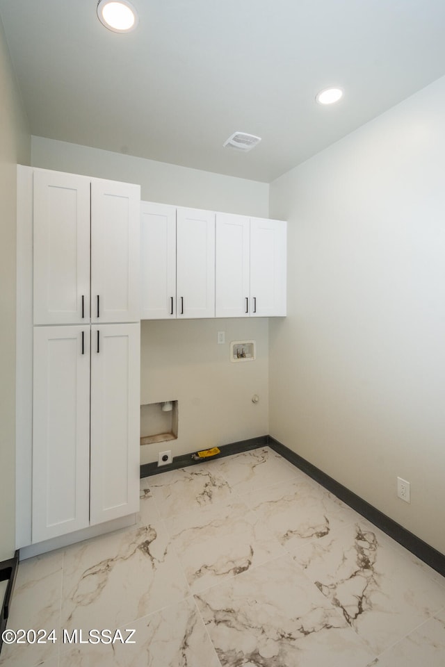 clothes washing area featuring washer hookup, cabinets, and electric dryer hookup