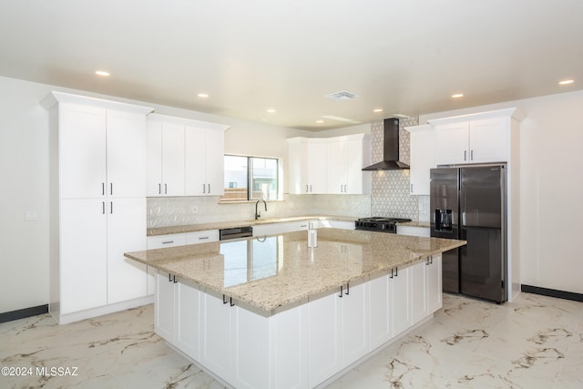 kitchen featuring wall chimney range hood, backsplash, white cabinets, stainless steel fridge with ice dispenser, and a center island