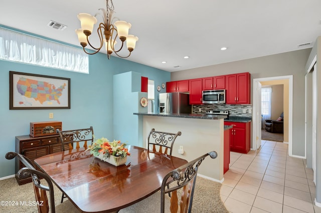 dining space featuring light colored carpet, baseboards, a chandelier, and visible vents