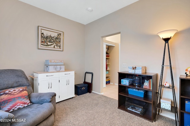 sitting room featuring baseboards and carpet