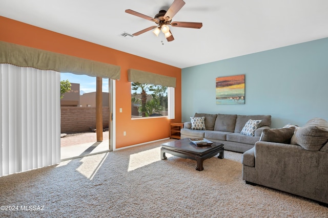 carpeted living area with visible vents and a ceiling fan