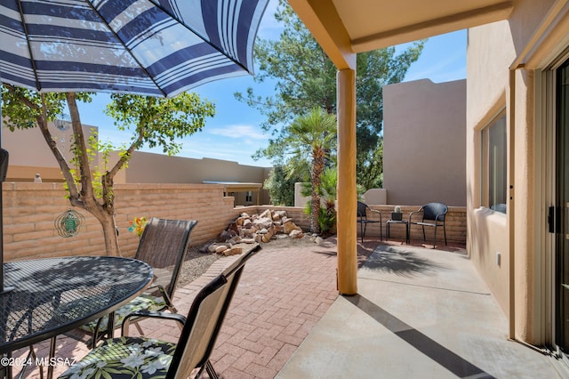 view of patio featuring fence and outdoor dining area