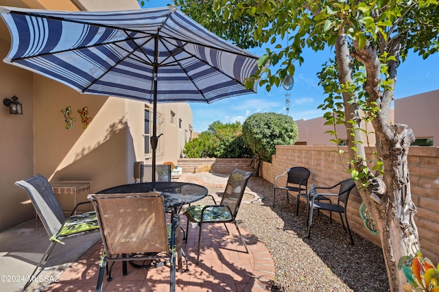 view of patio / terrace with outdoor dining space and fence