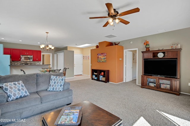 living room featuring recessed lighting, baseboards, light carpet, and ceiling fan with notable chandelier