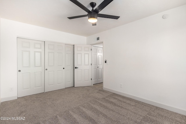 unfurnished bedroom featuring carpet and ceiling fan