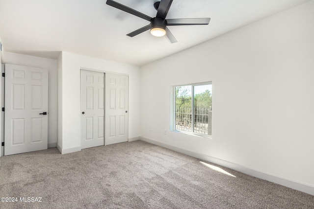 unfurnished bedroom featuring ceiling fan, a closet, and carpet