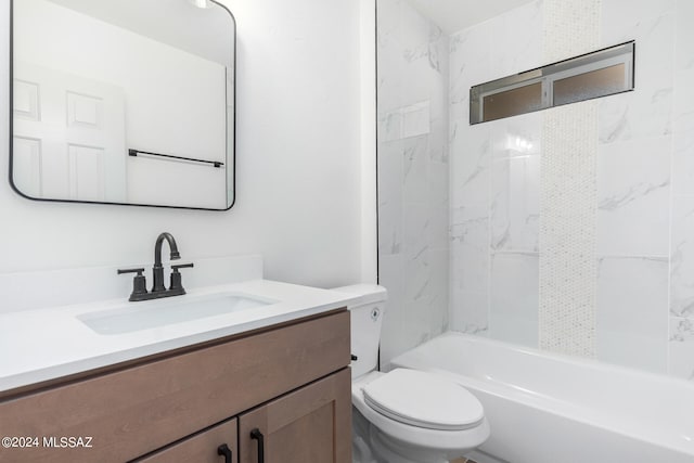 full bathroom featuring vanity, tiled shower / bath combo, and toilet