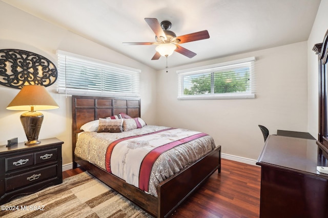 bedroom with lofted ceiling, dark hardwood / wood-style floors, and ceiling fan