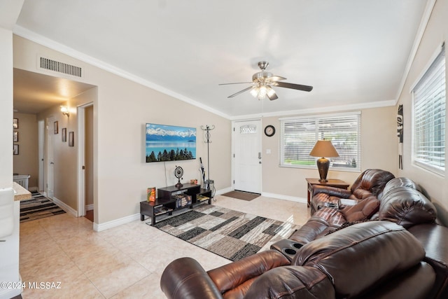 living room with ornamental molding, light tile patterned flooring, lofted ceiling, and ceiling fan