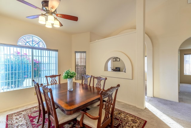 carpeted dining area featuring ceiling fan