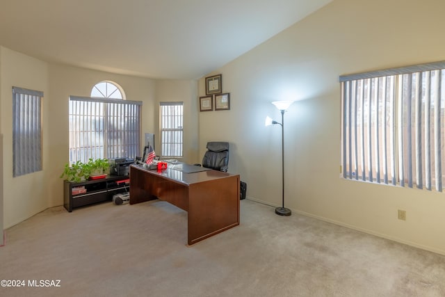 carpeted office space with vaulted ceiling