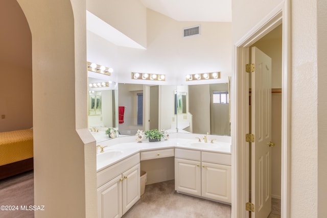 bathroom with vanity and vaulted ceiling