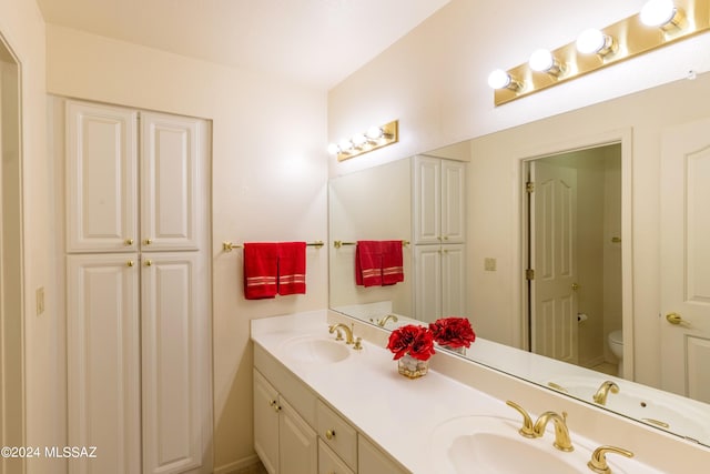 bathroom featuring toilet and vanity