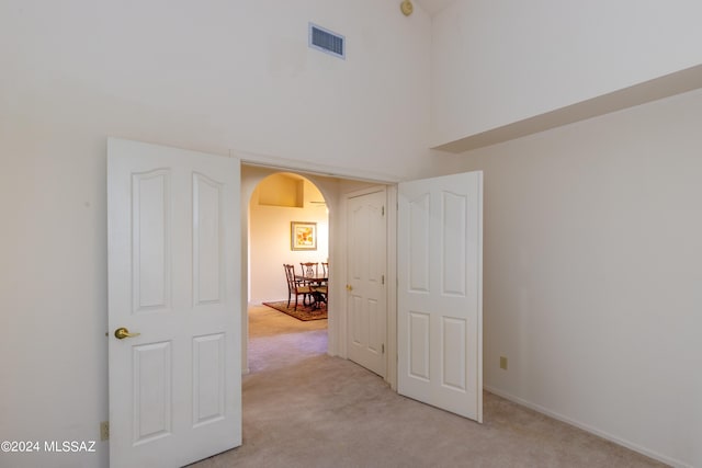 spare room featuring light colored carpet