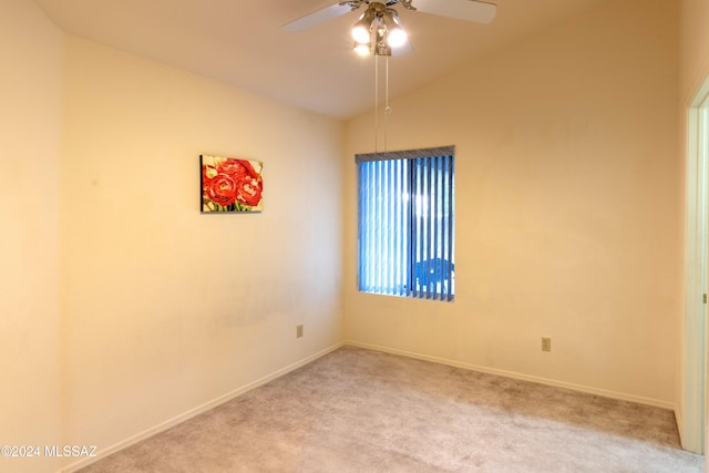 carpeted empty room featuring ceiling fan and vaulted ceiling