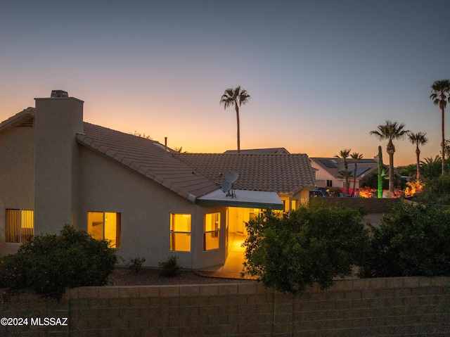 view of back house at dusk