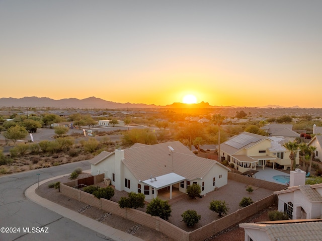 aerial view at dusk featuring a mountain view