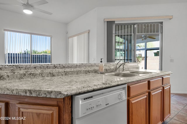 kitchen with a wealth of natural light, sink, white dishwasher, and light tile patterned flooring