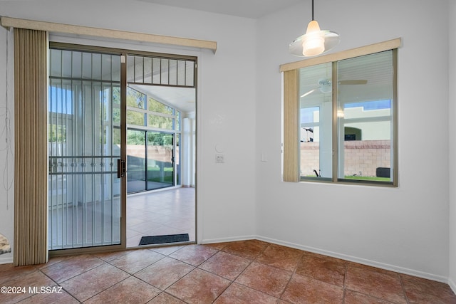 entryway with tile patterned floors and ceiling fan