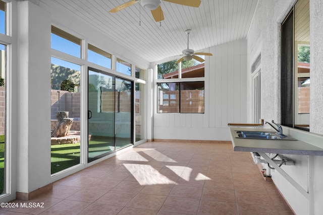 sunroom with wood ceiling, lofted ceiling, and sink