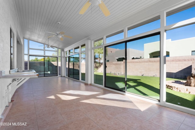 unfurnished sunroom featuring wooden ceiling and vaulted ceiling