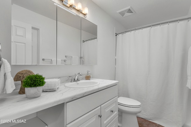 bathroom with tile patterned flooring, vanity, and toilet