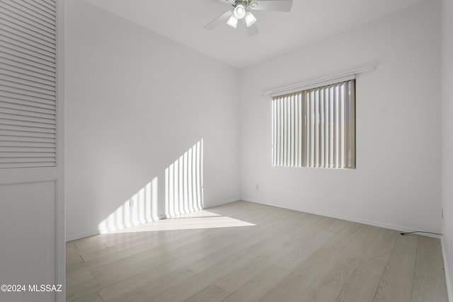 empty room featuring ceiling fan and light hardwood / wood-style floors