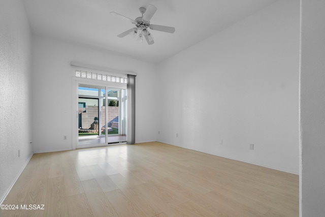 empty room with ceiling fan and light wood-type flooring