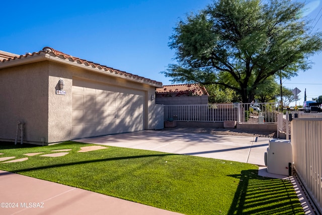 view of side of home with a garage and a yard