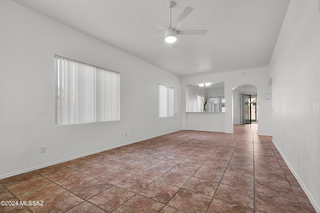 spare room with tile patterned floors and ceiling fan