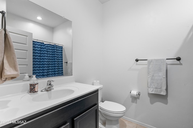 bathroom featuring vanity, tile patterned flooring, and toilet