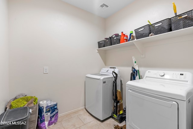 laundry room featuring independent washer and dryer and light tile patterned floors