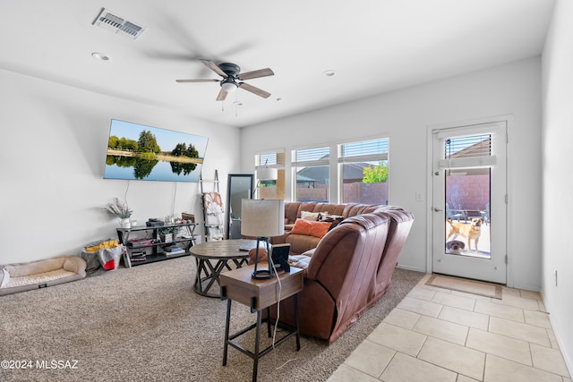 living room featuring light tile patterned floors and ceiling fan