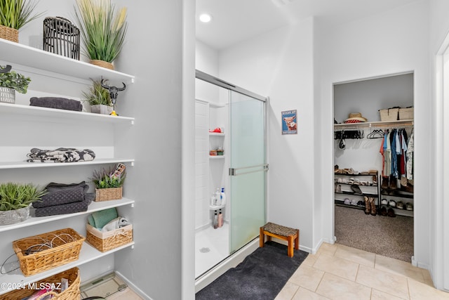 bathroom featuring tile patterned flooring and a shower with shower door