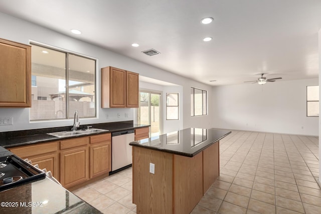 kitchen with light tile patterned floors, visible vents, a kitchen island, stainless steel dishwasher, and a sink