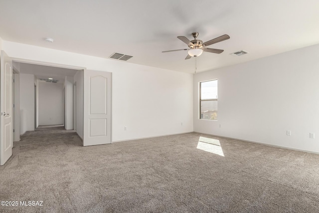 unfurnished room featuring baseboards, visible vents, ceiling fan, and carpet flooring