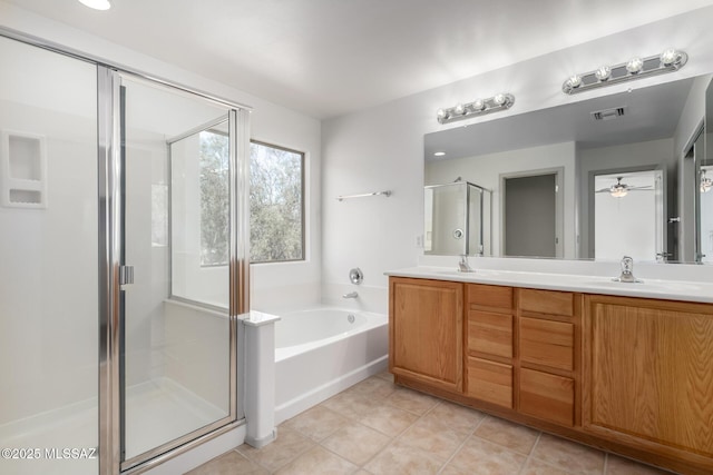 full bath featuring visible vents, a bath, tile patterned floors, double vanity, and a stall shower