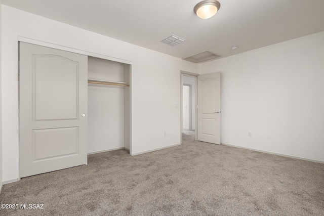 unfurnished bedroom with light carpet, a closet, visible vents, and baseboards