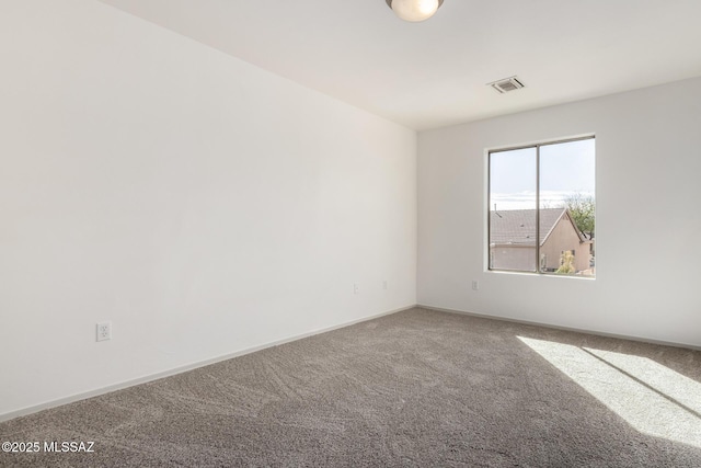 carpeted empty room with baseboards and visible vents