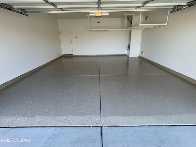 garage with baseboards and a garage door opener