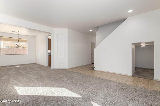 empty room with light tile patterned floors, recessed lighting, a notable chandelier, light colored carpet, and visible vents