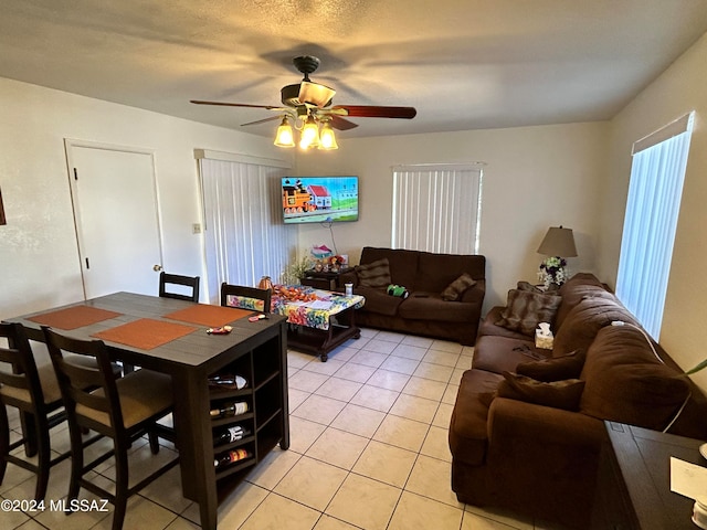 tiled living room featuring a textured ceiling and ceiling fan