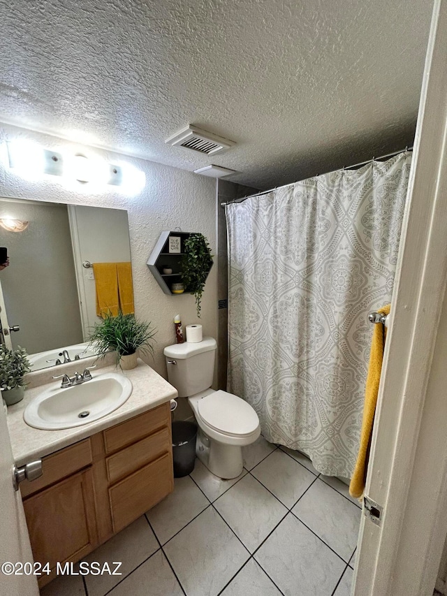 bathroom with a textured ceiling, toilet, a shower with curtain, vanity, and tile patterned flooring