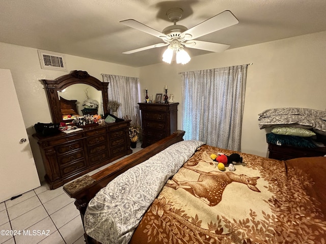 tiled bedroom featuring ceiling fan