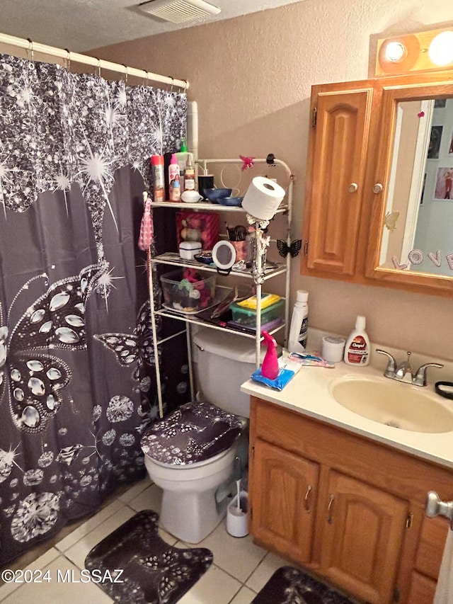 bathroom featuring vanity, a shower with curtain, toilet, and tile patterned floors