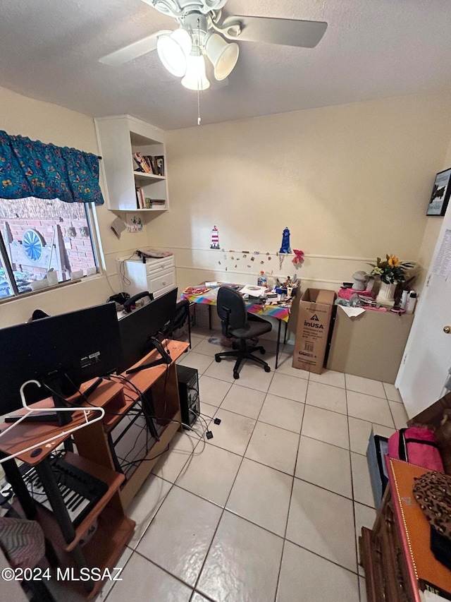 office featuring built in desk, tile patterned floors, and ceiling fan